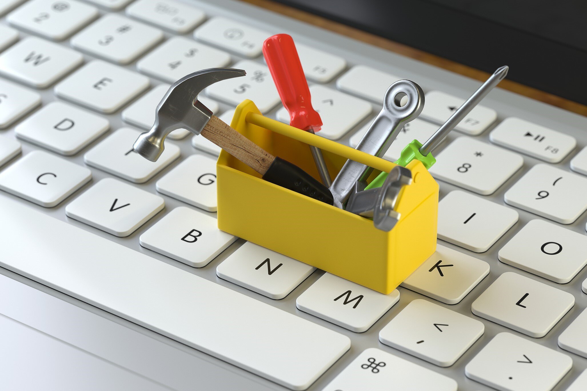 Small yellow tool box on a laptop keyboard
